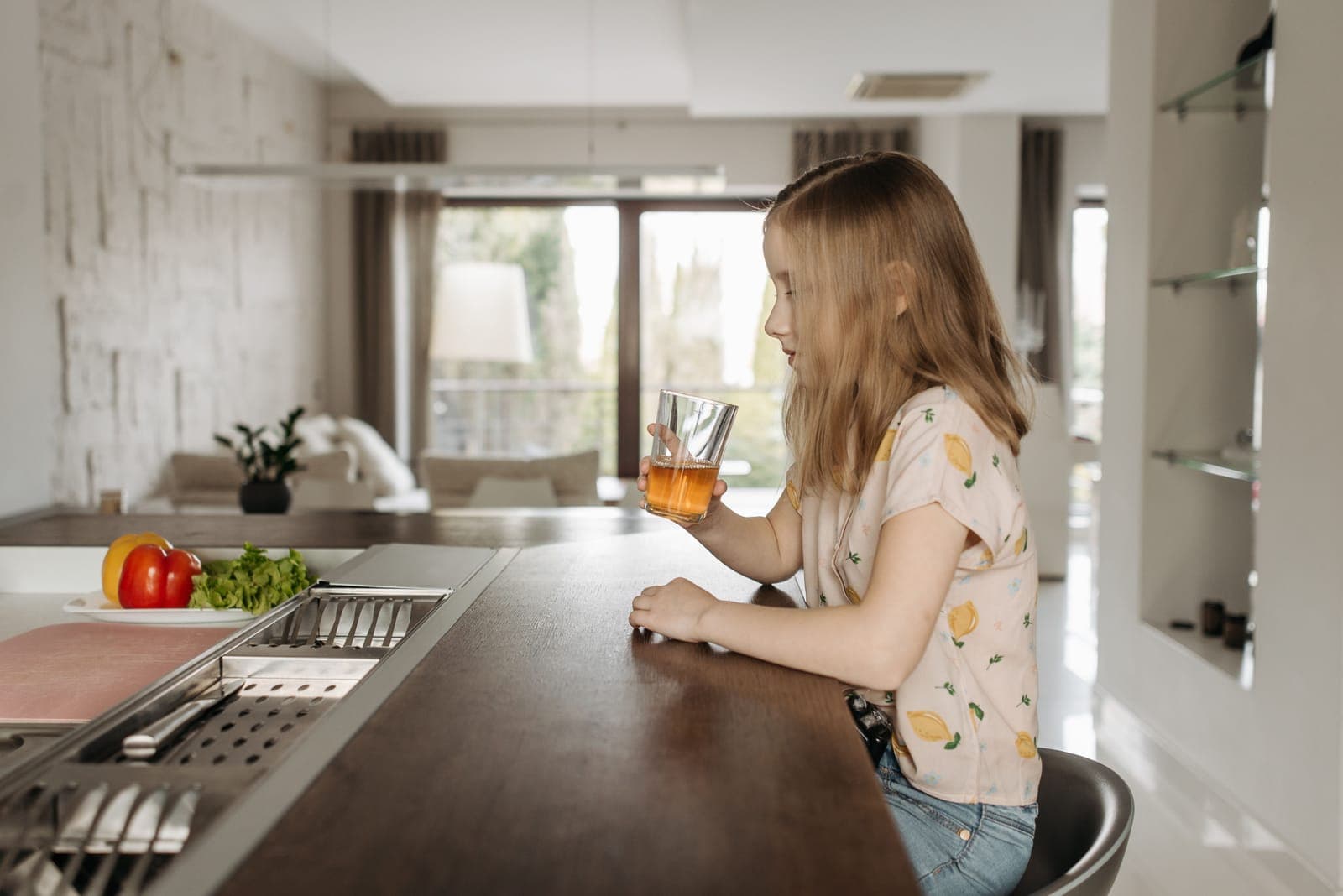 A glass of fresh green juice on a bright kitchen counter