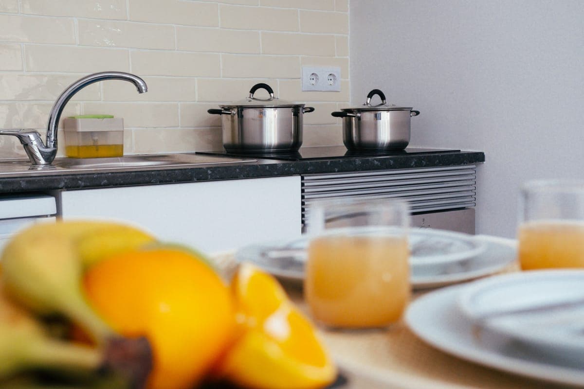 A horizontal juicing machine on a kitchen counter