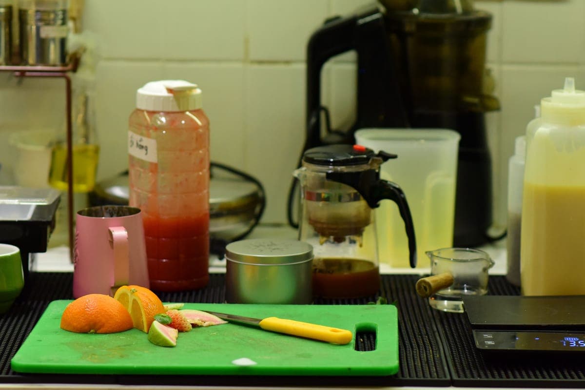 A vertical slow juicer on a bright kitchen counter