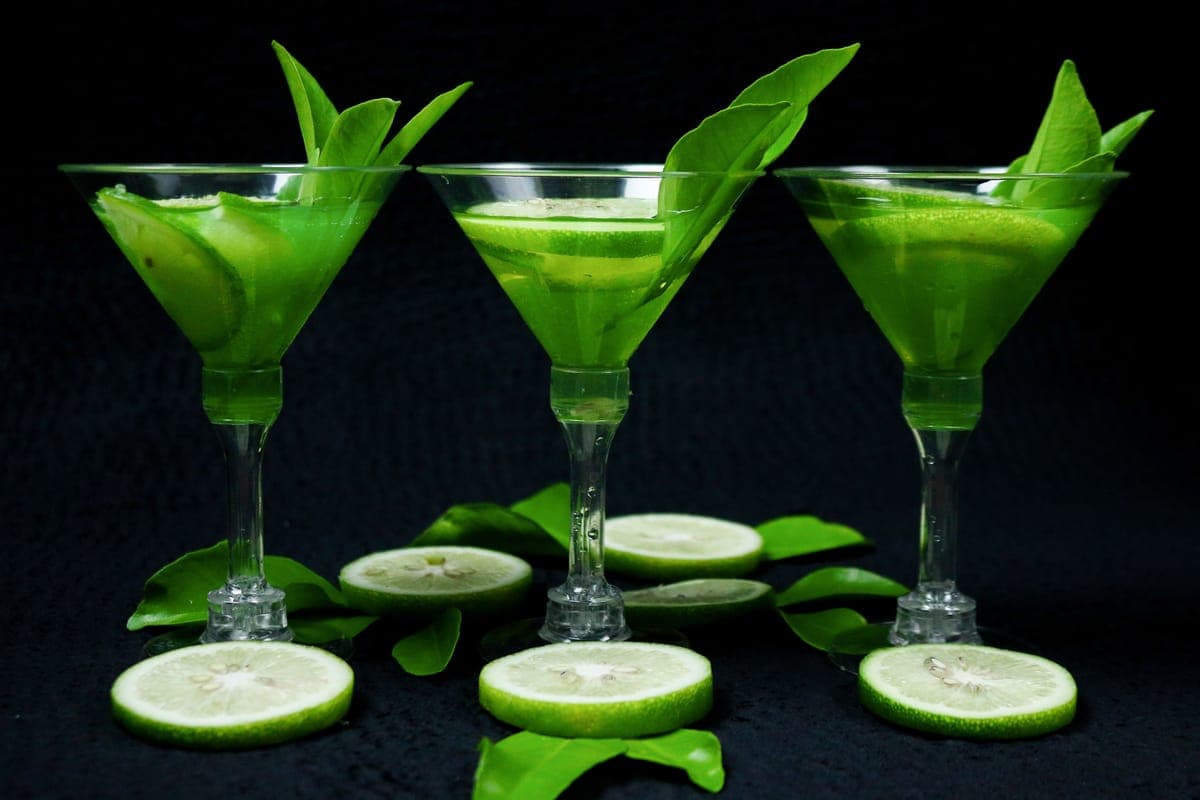 Citrus halves and a lime drink on a bar counter