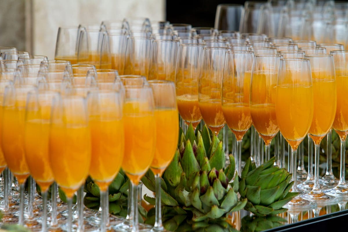 A row of colorful juices in glasses