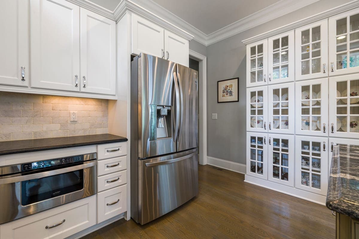 A kitchen cabinet with a stored appliance